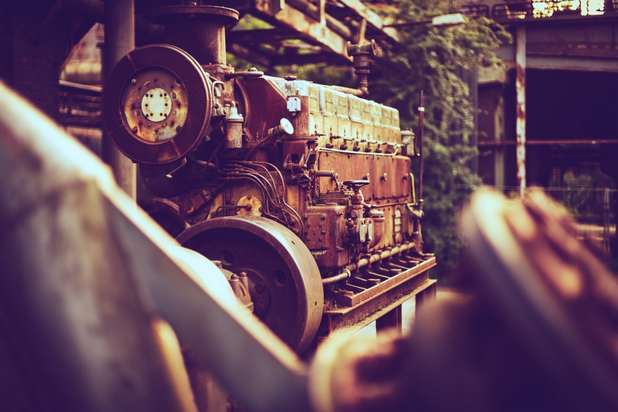 mechanic repairing large diesel generator workshop